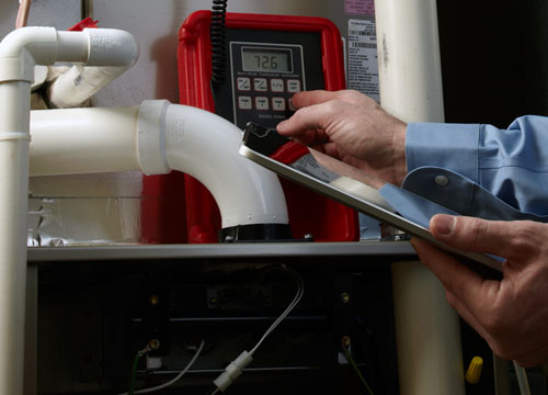 A Technician Inspects An HVAC System. Schedule Your Heating Service Call From Hometown Heating & Air Today.